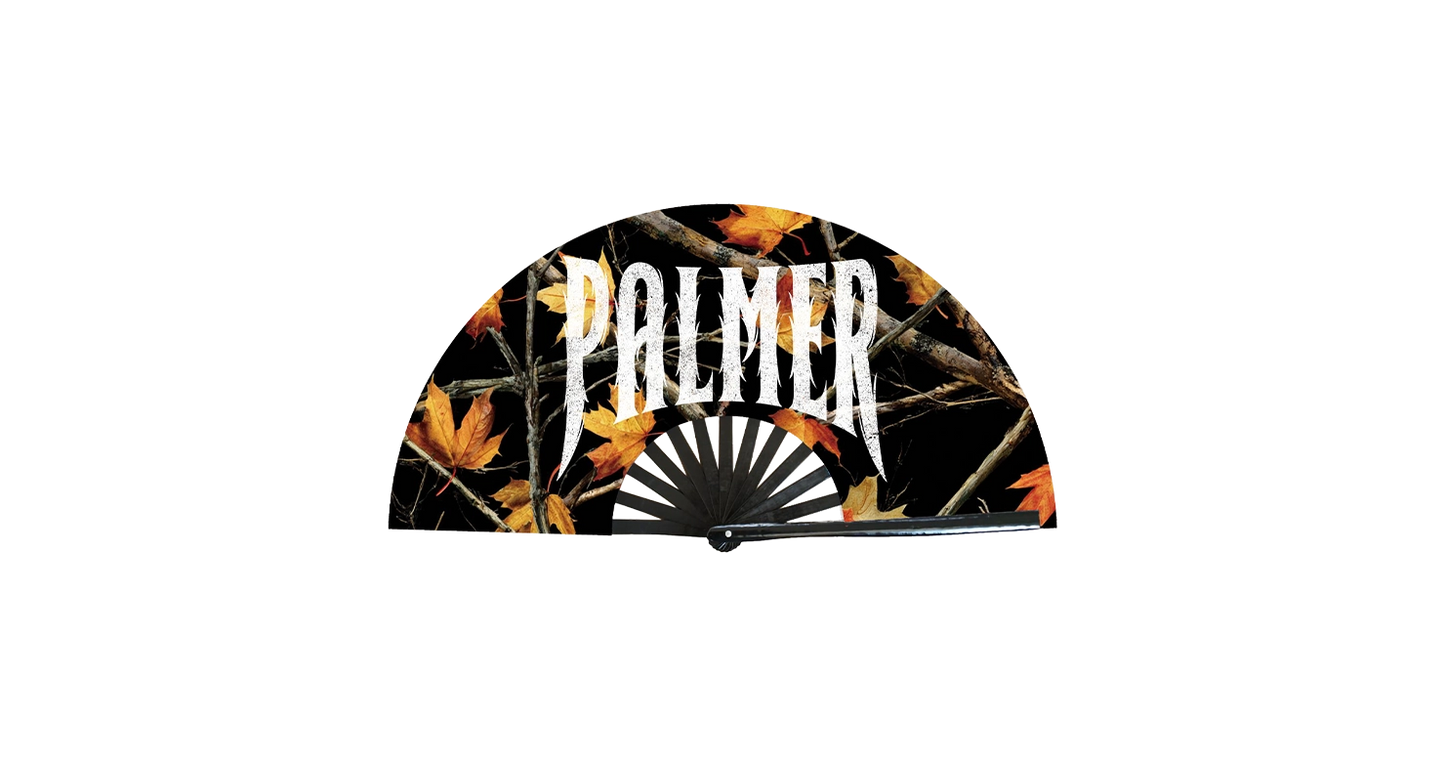 Black hand fan with autumn leaf design and 'Palmer' branding on a white background